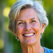 Lisa K., 51, smiling brightly with outdoor background
